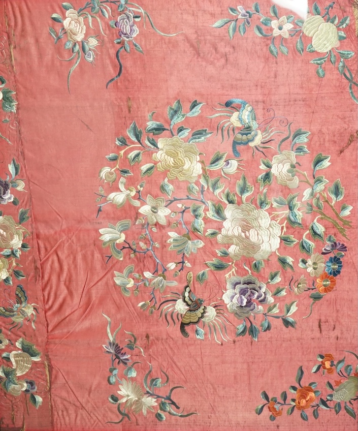 A pair of framed early 20th century Chinese silk embroideries, probably panels cut from a larger embroidery or bed cover. Embroidered with a large central cartouche of flowers birds and butterflies. 89cm x 73cm. Conditio